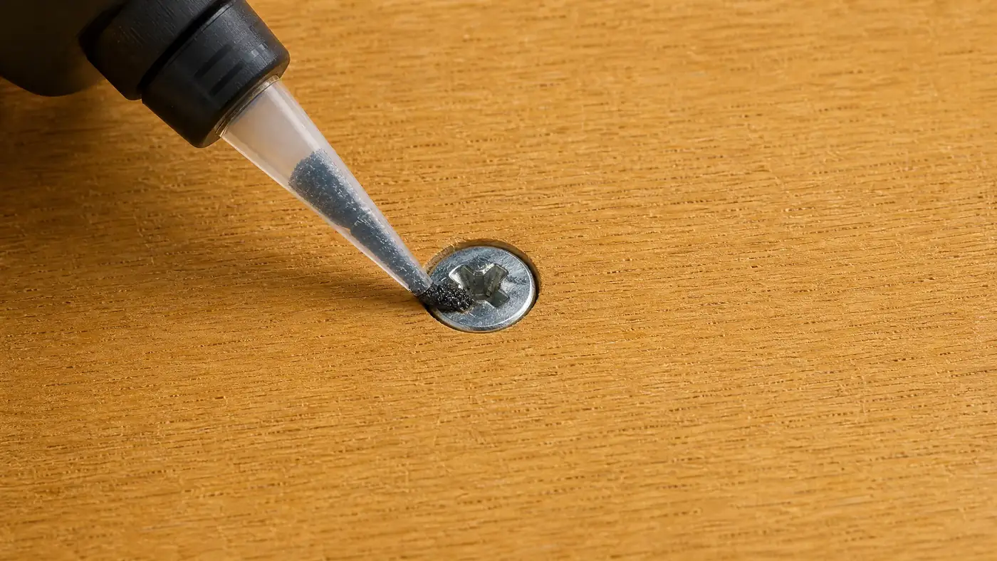 Grip compound being applied into the recess of a stripped screw